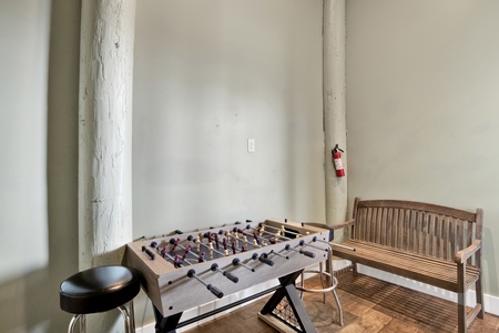 Downstairs game room with foosball table