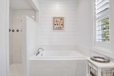 The master bath features a soaking tub and a large walk-in tiles shower