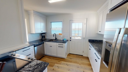Fully equipped kitchen with access to back deck
