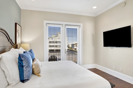 Bedroom 2 has a TV and an attached bathroom that also has a hall entrance