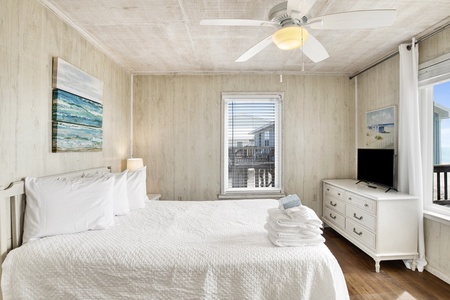 Bedroom 2 has a ceiling fan,TV and an attached half bath