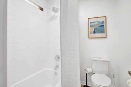 The bathroom has a tub/shower combo