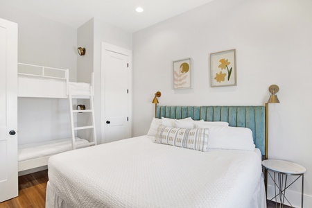 Bedroom #2 on the 2nd floor sleeps 4 in a king and twin bunks. There is a TV and a private bathroom