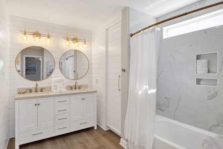 The primary bathroom features double vanities and a tub/shower combo