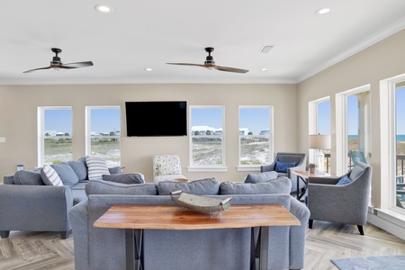 Living area features a large mounted TV and comfortable seating