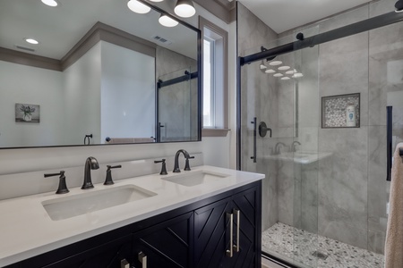Double vanities and walk-in tile shower