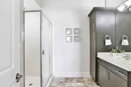 The private bath in bedroom 4 has a walk-in shower