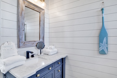 The bathroom in bedroom 1 comes with a makeup mirror