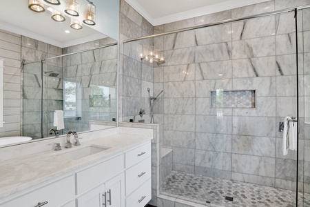 The private bathroom features a walk-in tile shower