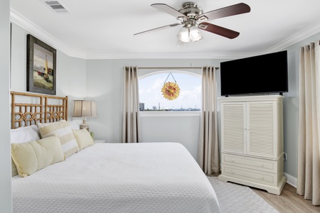 This guest bedroom offers a King bed, TV and private bathroom