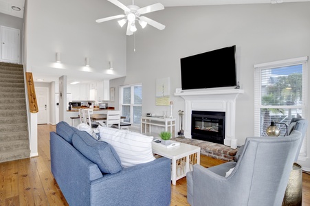 The living room offers balcony access and a sleeper sofa, sleeps 2