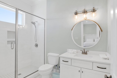 The guest bathroom features a walk-in, tile shower