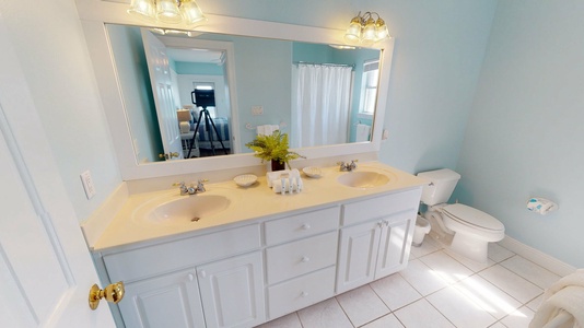 Bedroom 4 bathroom features a large vanity with shower/tub combo