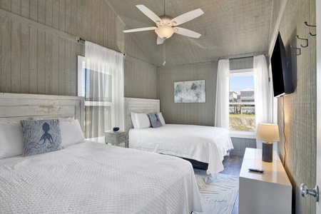 Bedroom #2 features 2 full beds and a television