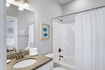 The attached bathroom features a tub/shower combo and is accessible from the hallway