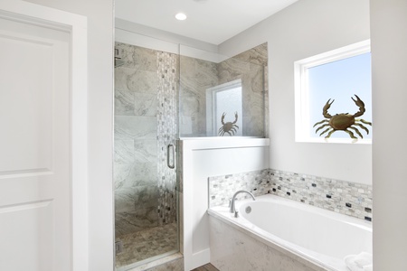 Relaxing soaking tub and large tiled walk-in shower
