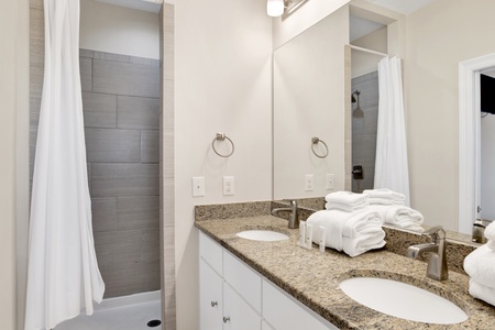 Private master bath with a double vanity and a walk-in shower