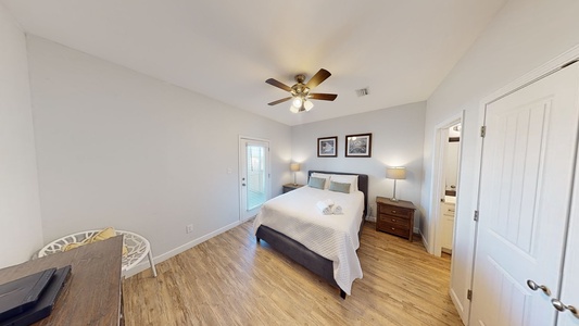 Bedroom 2 is on the 1st floor and features a queen bed and access to the screened-in porch