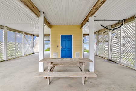 Multiple picnic tables and outdoor storage