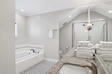 3rd floor south master bath with a double vanity and a soaking tub