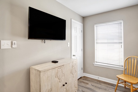 2nd floor bunk bedroom has a TV and shares the hallway bathroom