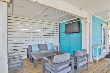 Outdoor covered patio with TV under the home