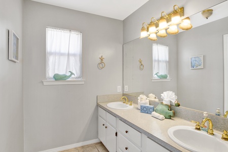 2nd floor shared hall bathroom with a double vanity and a tub/shower combo