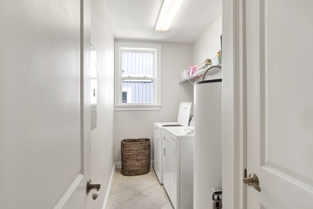 Separate laundry room with full size washer and dryer