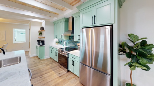 Stainless appliances and a tile backsplash in this fully equipped kitchen