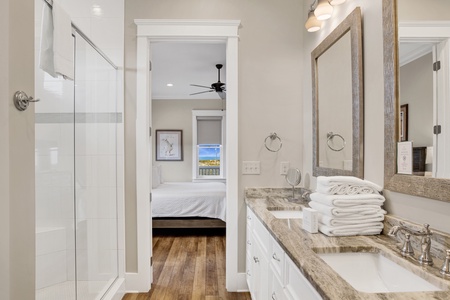 The primary bathroom has double vanities and a large, walk-in closet