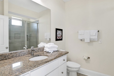The private bath in Bedroom 2 has a walk-in shower