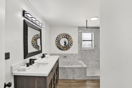 The master bathroom has double vanities, large tub and standing shower