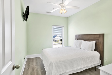 Bedroom 4 on the 2nd floor comes with a queen bed, TV and shares a hall bathroom