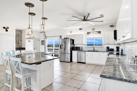 Beautiful stainless appliances, stone counters and tile backsplash