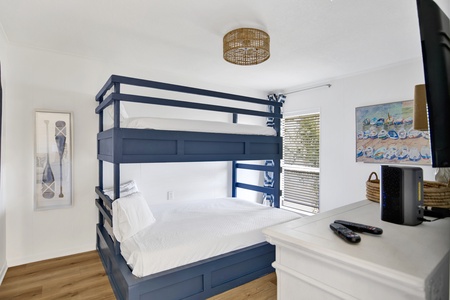 The guest bedroom has a custom Twin over Queen bunk bed, sleeps 3 guests