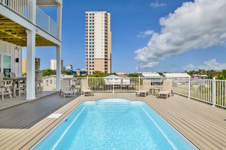 The pool area is accessible from the living room and provides a covered and uncovered area for relaxation or tanning