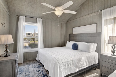 1st floor master bedroom features a queen bed and a TV