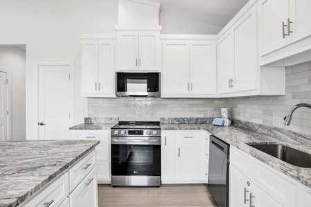 Beautiful granite countertops, tile backsplash and stainless appliances