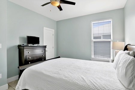 Bedroom 2 has a TV and a ceiling fan