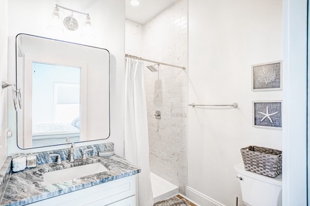 2nd floor guest bathroom located in hall with a tiled walk-in shower