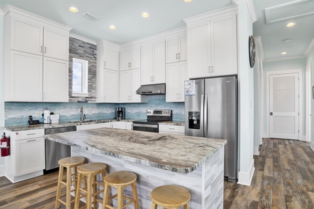 The main kitchen is fully equipped, has stone counters and stainless appliances