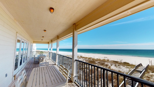 Top floor balcony with a dining table and chairs