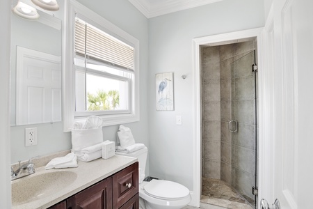 The private bathroom features a walk-in tile shower