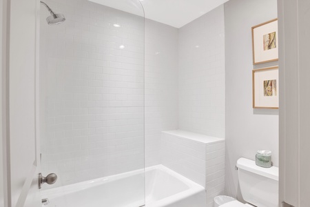 The shared hall bath has a tub/shower combo