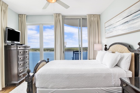 Guest bedroom 1 offers a Queen bed, TV, balcony access with Lagoon views and a private bathroom