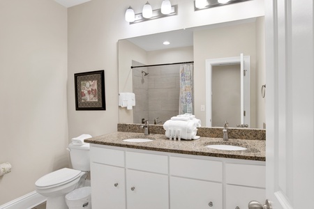 Shared hall bathroom on the 2nd floor with a double vanity and a tub/shower combo
