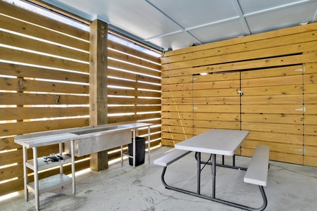 Fish cleaning station, BBQ grills and picnic table under the carport