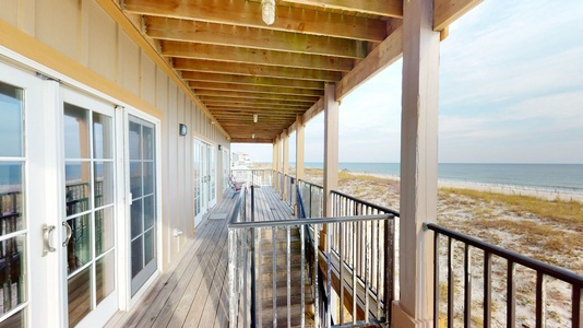 2nd floor balcony with stairs that lead to the pool, beach walk-over and under the home