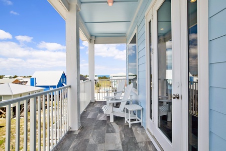 The covered balcony has views of Mobile Bay