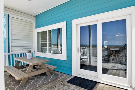 Covered porch with picnic table for outdoor dining